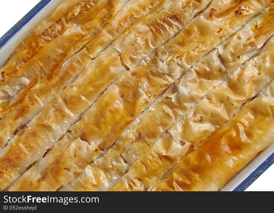 Banitsa is a traditional Bulgarian pastry prepared by layering a mixture of whisked eggs and pieces of pumpkin between filo pastry and then baking it in an oven. Banitsa is a traditional Bulgarian pastry prepared by layering a mixture of whisked eggs and pieces of pumpkin between filo pastry and then baking it in an oven.