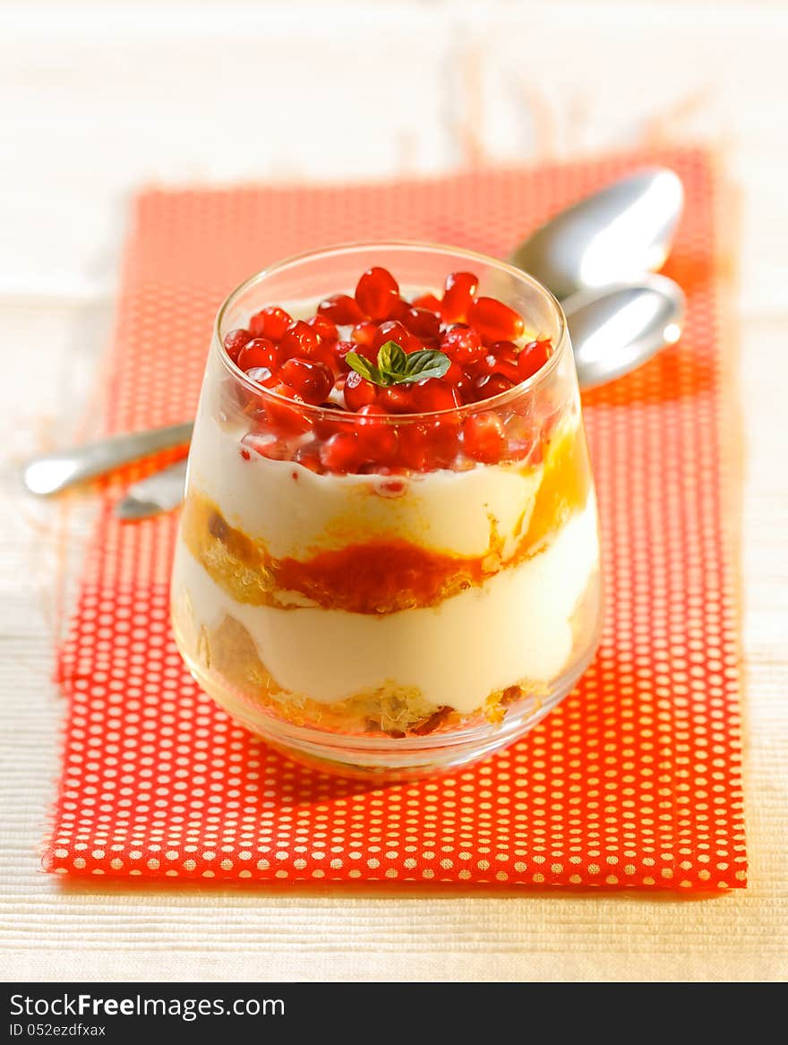 Healthy dessert made from yogurt, sponge cake and pomegranate in small glass. Healthy dessert made from yogurt, sponge cake and pomegranate in small glass