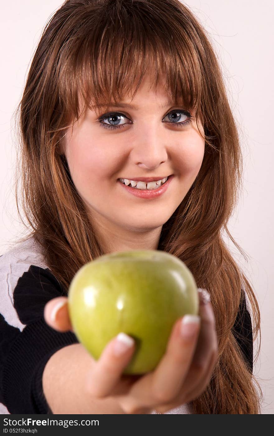 Teen girl holding an apple.