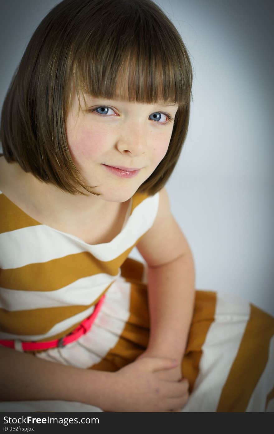 A simple colour portrait of a pretty young girl with striking blue eyes. A simple colour portrait of a pretty young girl with striking blue eyes.