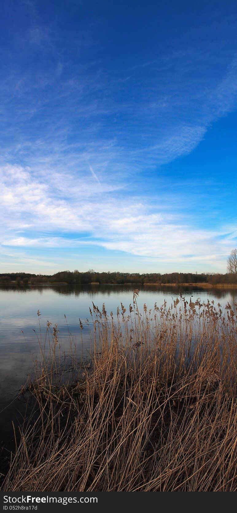 Becalmed lake with awesome blue sky