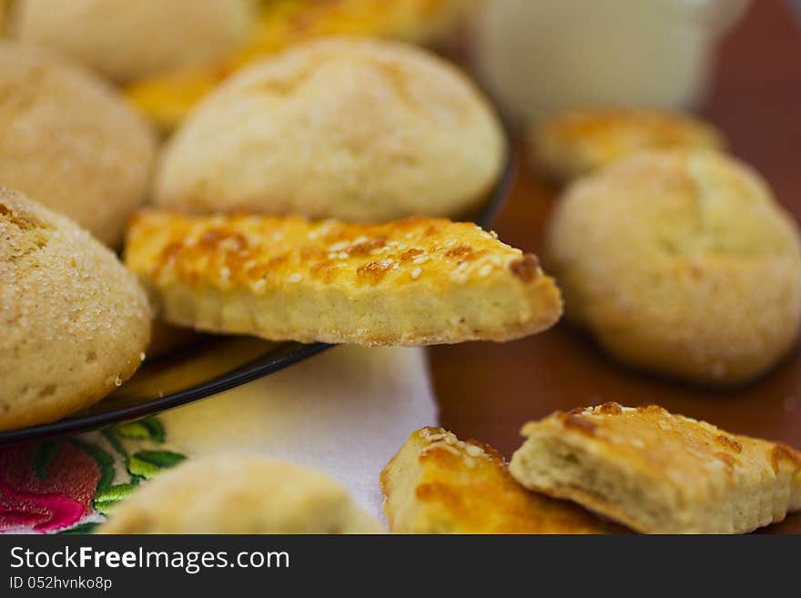 Delicious fresh baked cookies in plate and on table. Delicious fresh baked cookies in plate and on table.