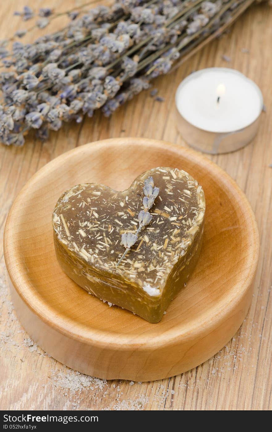 Bath Soap With Lavender In A Heart And A Candle On A Wooden Tabl