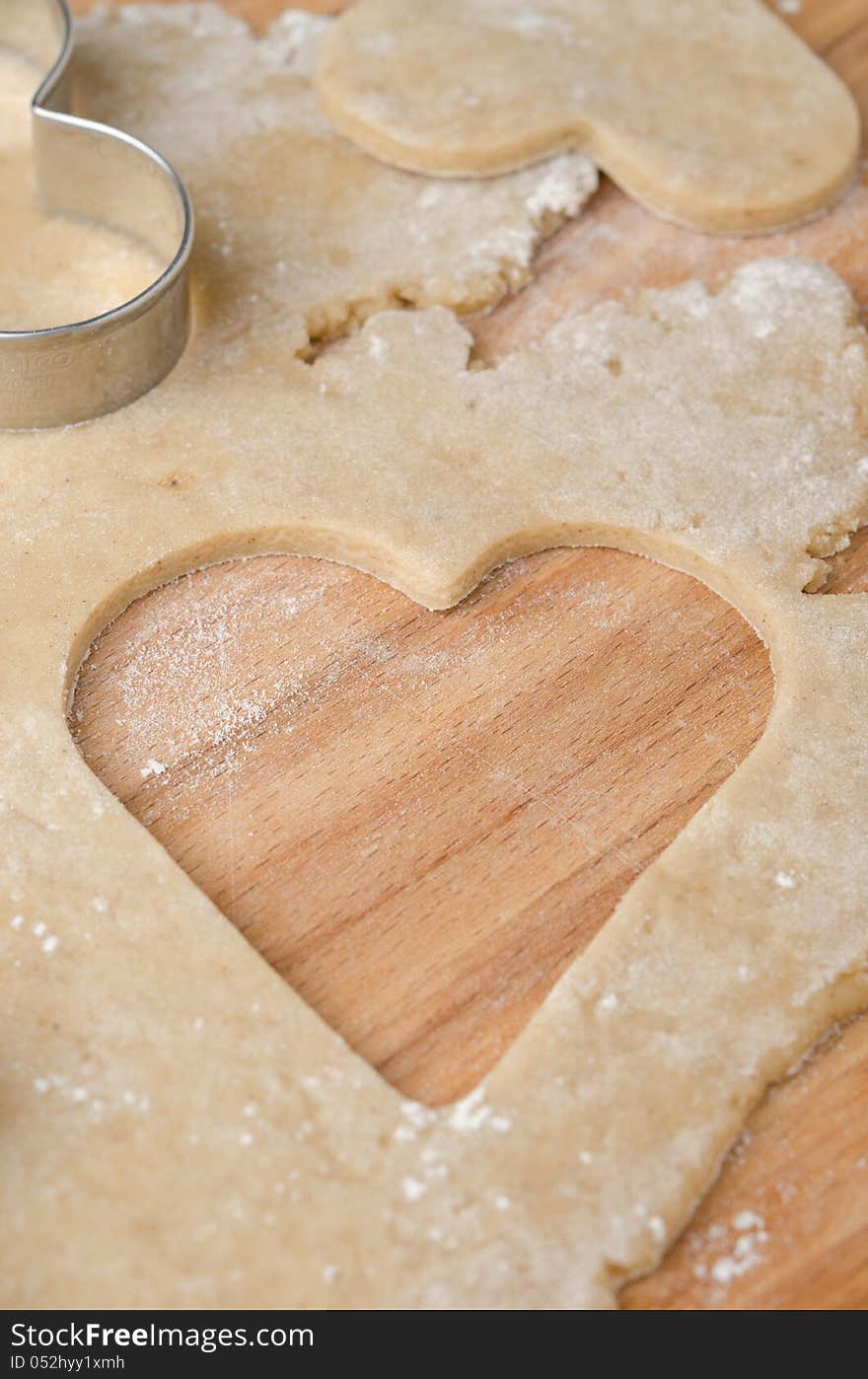 Hole in the shape of heart in cookie dough closeup