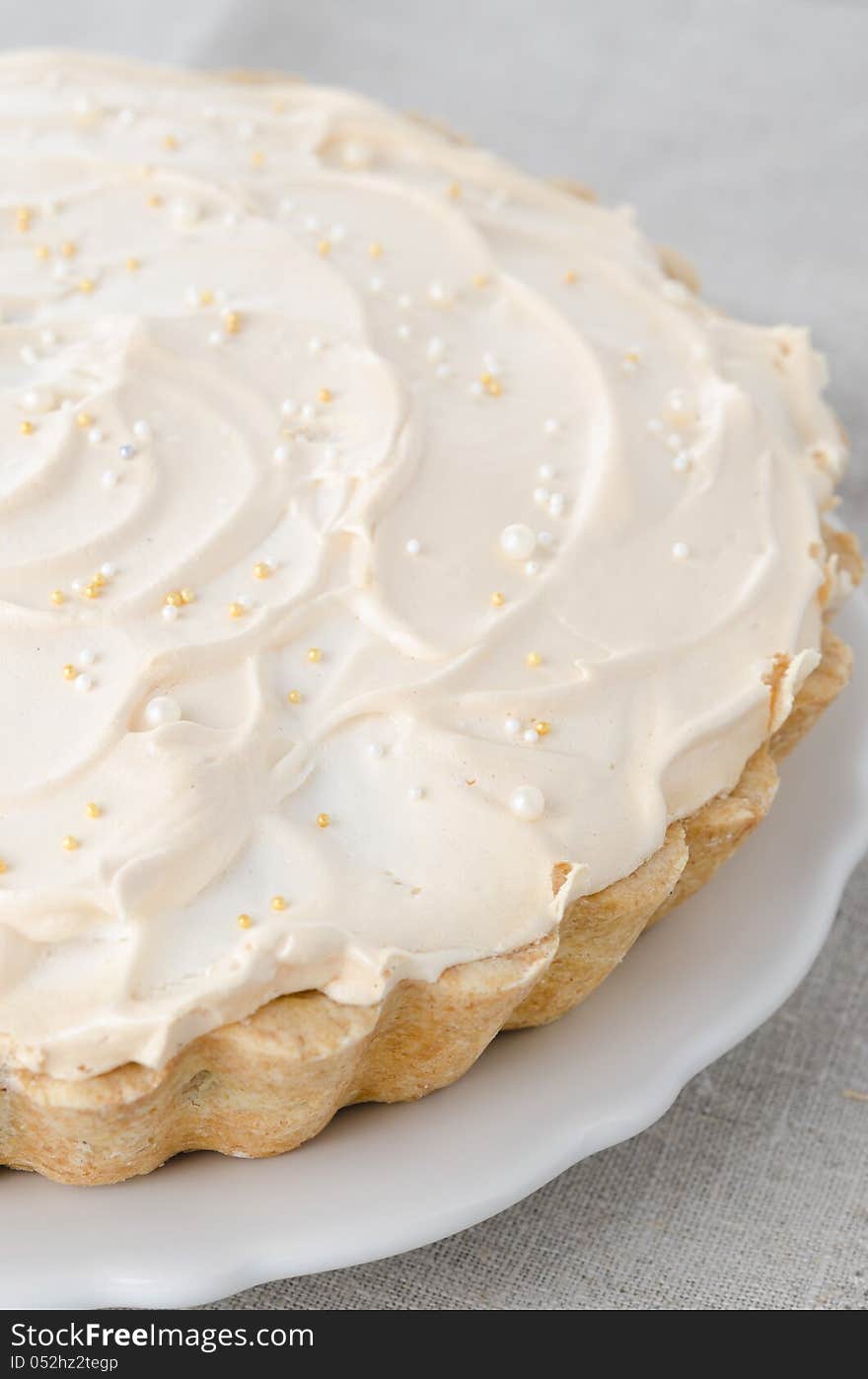 Lemon tart with meringue on a plate closeup