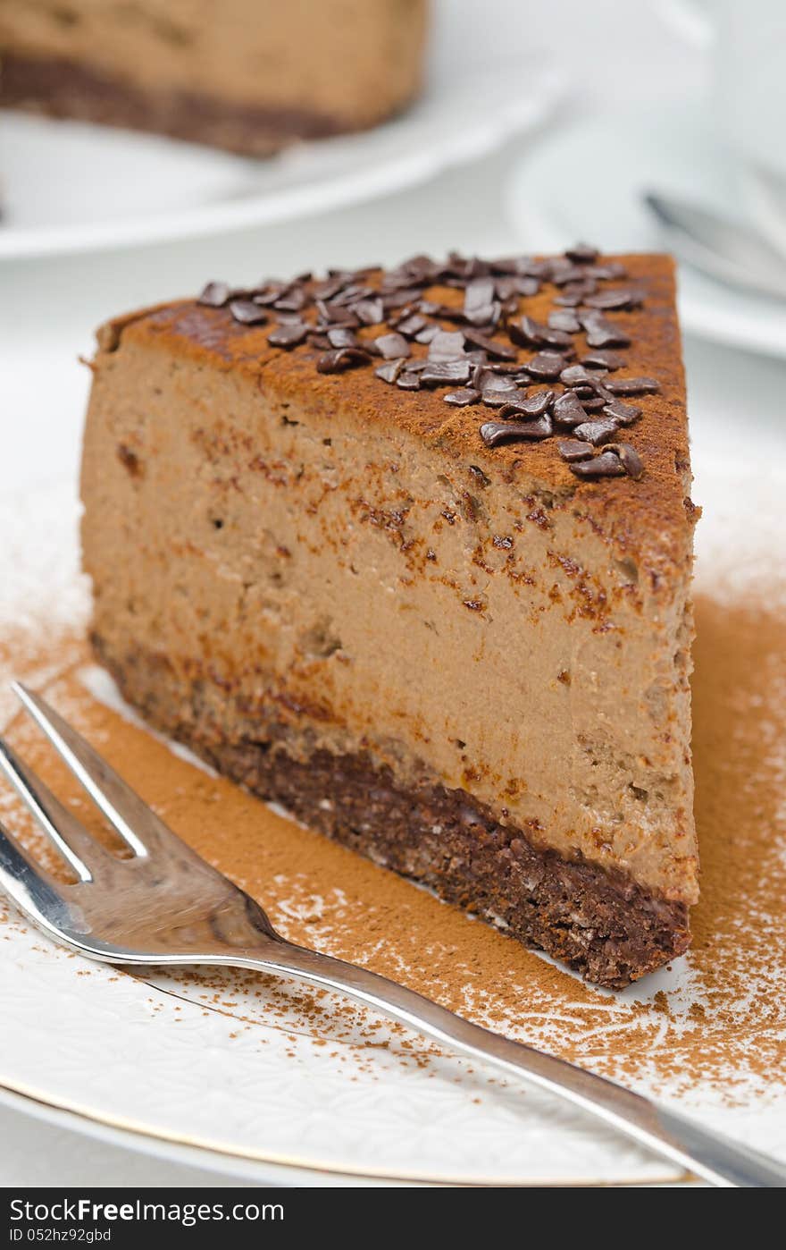 Piece of chocolate cheesecake on a plate closeup selective focus