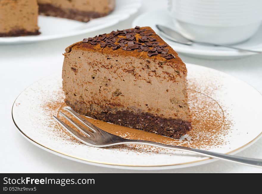 Piece of chocolate cheesecake on a plate closeup horizontal