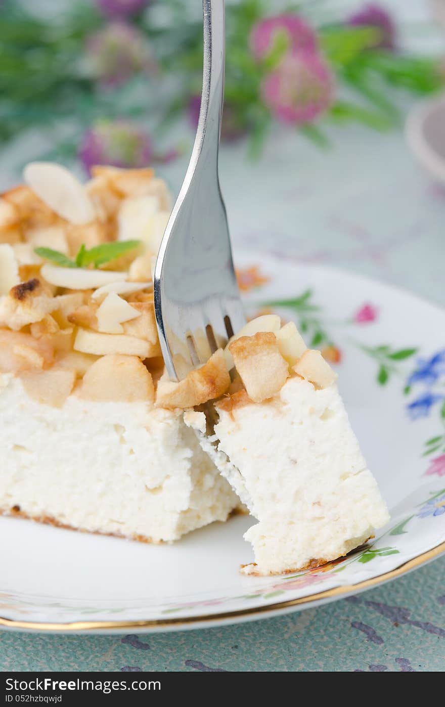 Piece of cottage cheese with apple pie with a fork