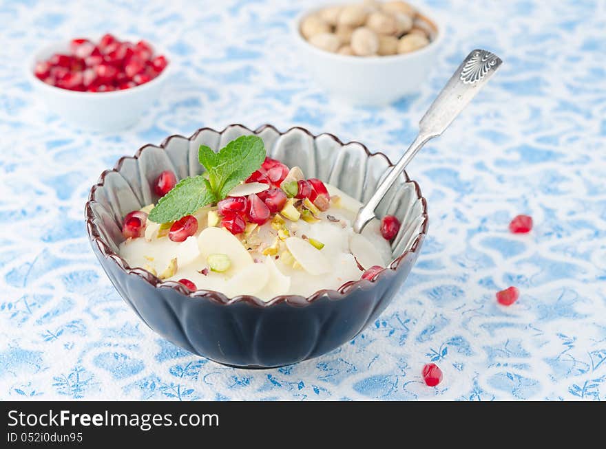 Semolina dessert with pomegranate seeds and pistachios in a bowl