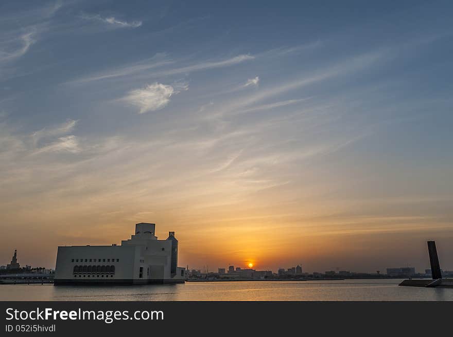 Museum of Islamic Art in Doha agains the setting sun with the'seven' monument' to the right. Museum of Islamic Art in Doha agains the setting sun with the'seven' monument' to the right.