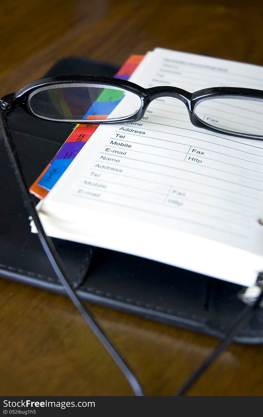 Eyeglasses put on page of personal organizer. Eyeglasses put on page of personal organizer