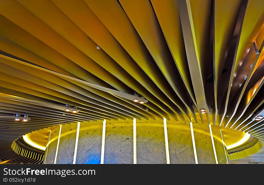 Ceiling graphic design of a modern building illuminated with yellow lighting. Ceiling graphic design of a modern building illuminated with yellow lighting