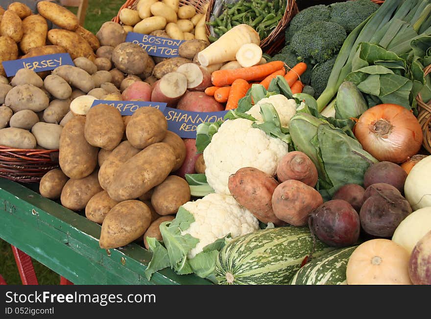 A Wooden Trolley Holding a Display of Fresh Vegetables.