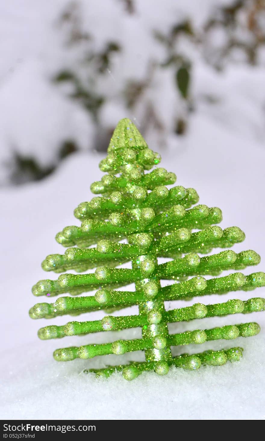 Image of a Christmas tree ornament on snow