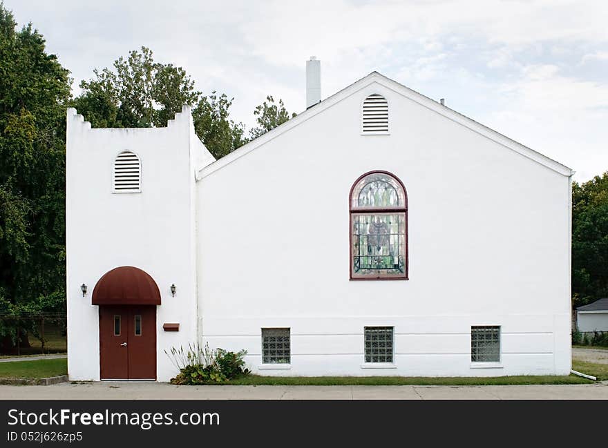 Small, white, stucco, neighborhood church in a simple Spanish design. Small, white, stucco, neighborhood church in a simple Spanish design.