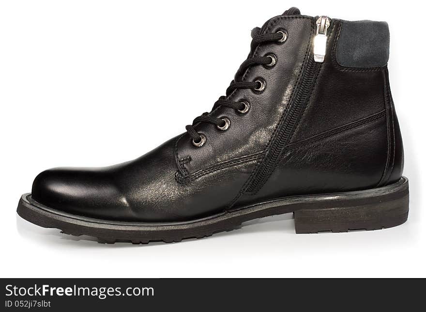 Classical black leather mans ankle high laceup boot for everyday formal wear on a white studio background. Classical black leather mans ankle high laceup boot for everyday formal wear on a white studio background