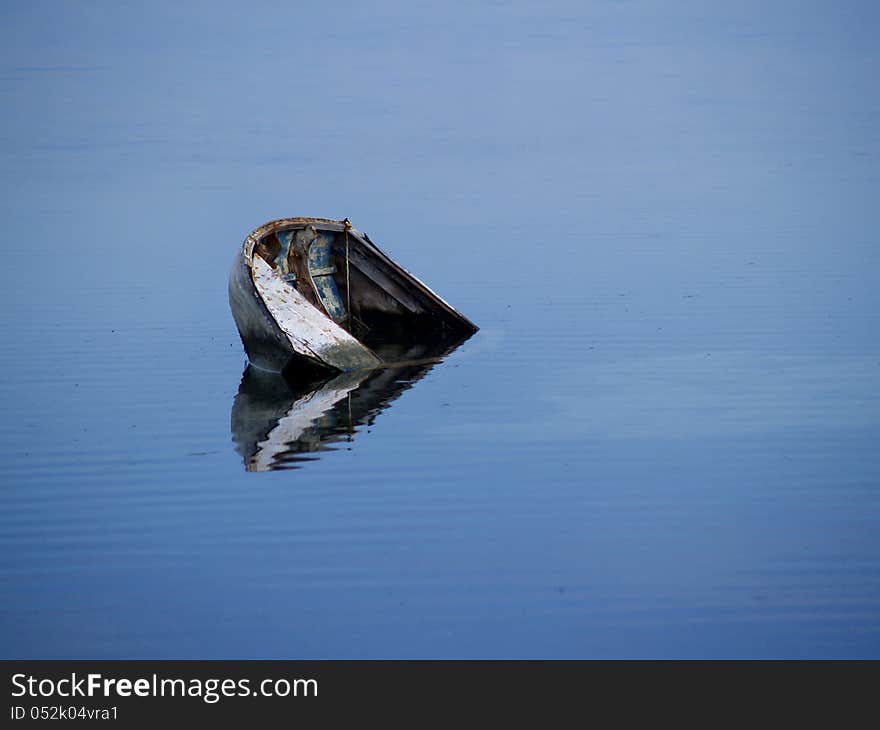 Sunken boat in blue waters