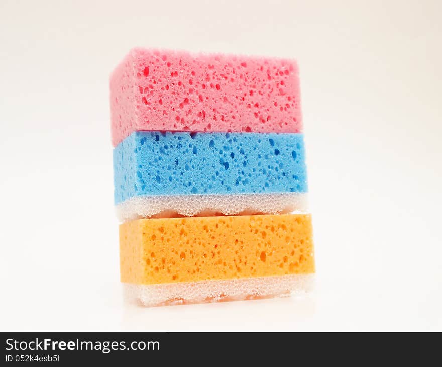 Pink, blue and orange sponge, towards white background