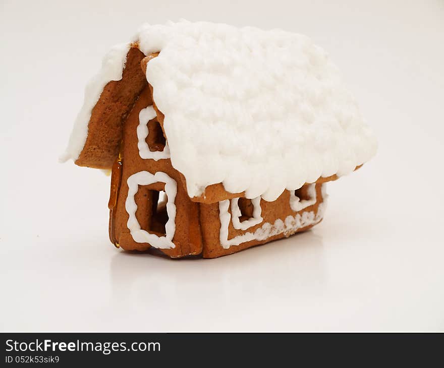 Gingerbread house, heavy icing, towards grey background