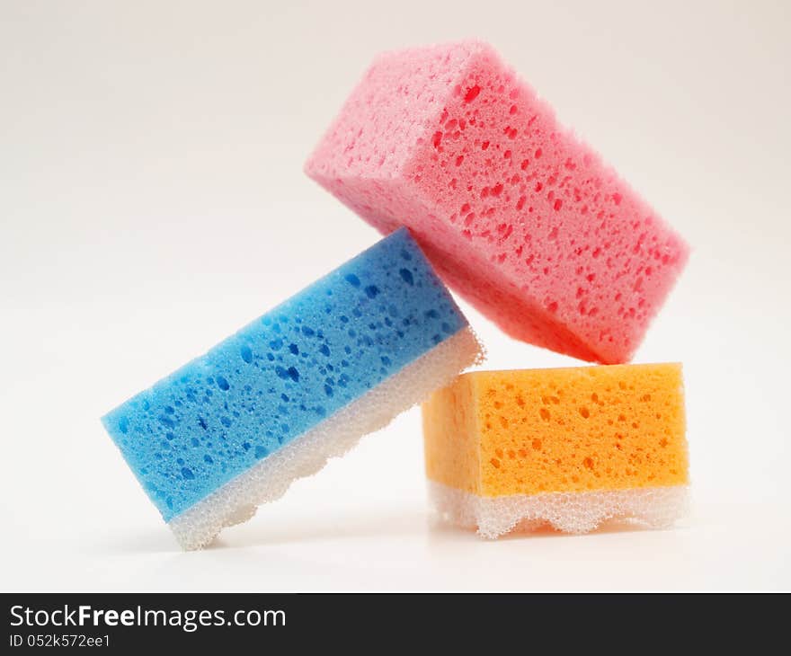 Pink, blue and orange sponge, towards white background