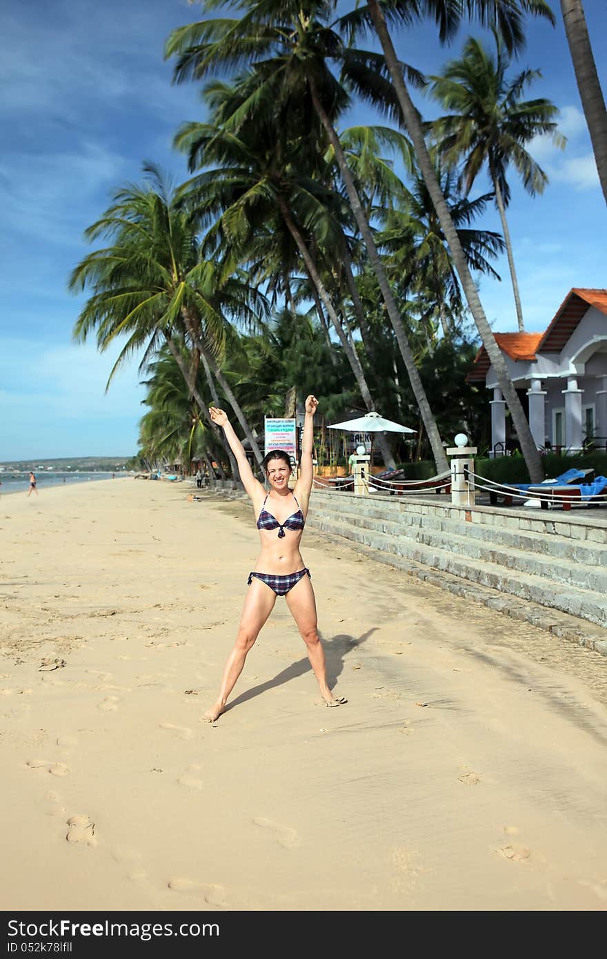 Cheerful active woman on the beach