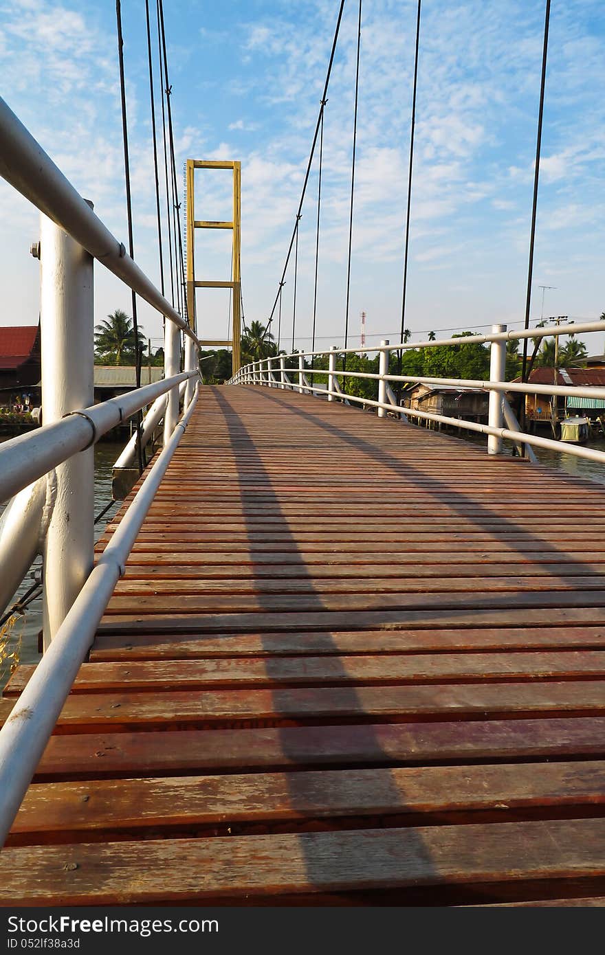 Wooden way on cable bridge with blue sky and cloudy