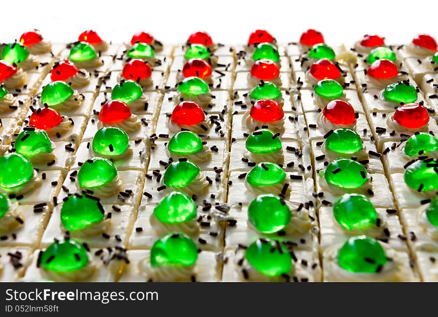 Isolates of cake squares with a green and red jelly on it greatly. Isolates of cake squares with a green and red jelly on it greatly.