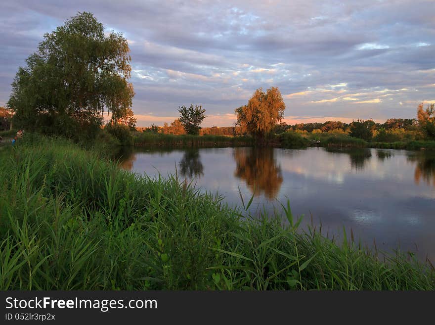 Country landscape. Pond in the twilight of day. Country landscape. Pond in the twilight of day.