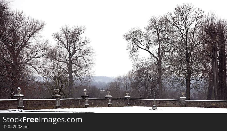 Old castle garden with classic ornaments in the snow