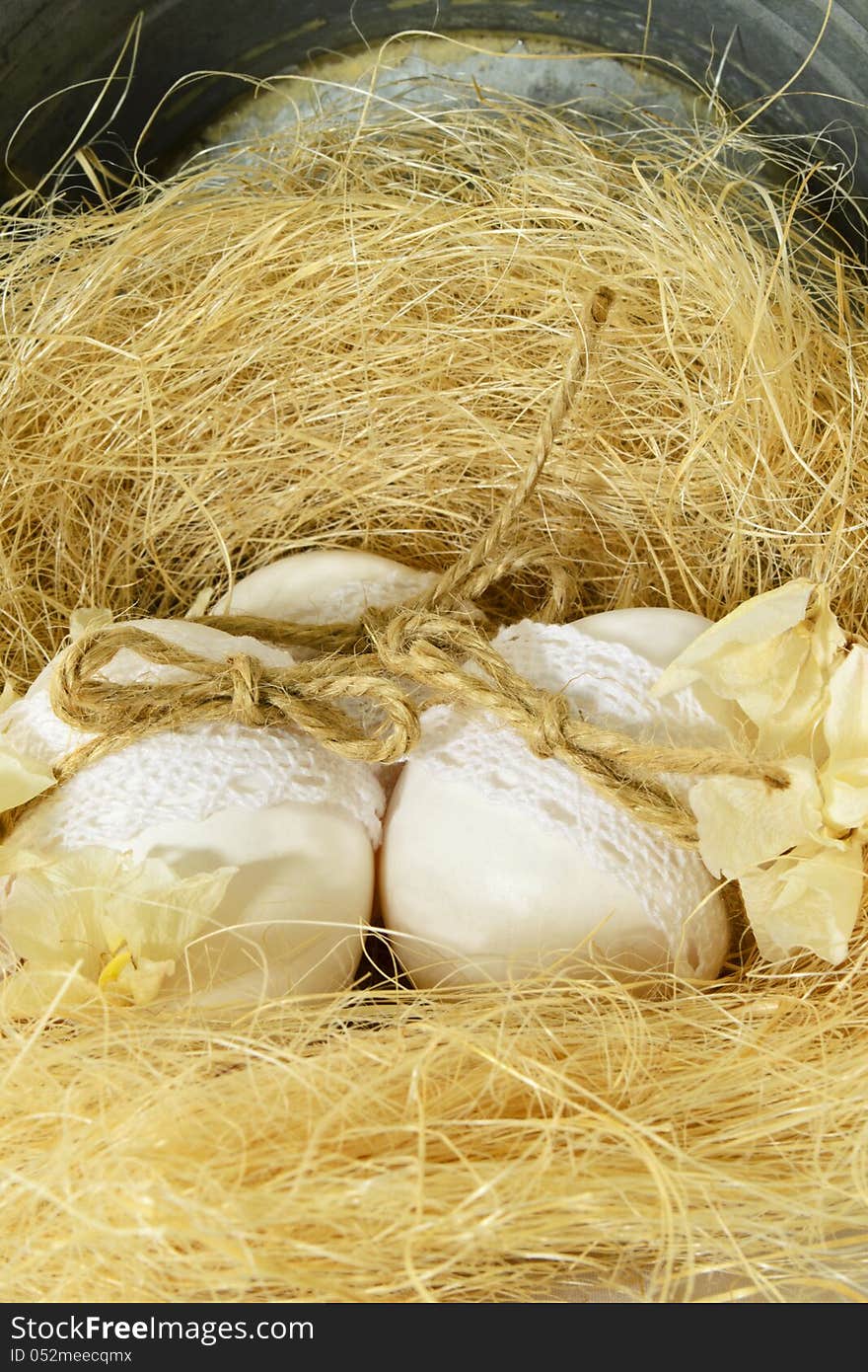 Three easter eggs in the nest of false grass. Three easter eggs in the nest of false grass