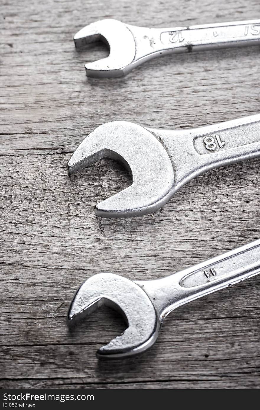 Wrenches on old wooden plank,black and white photo