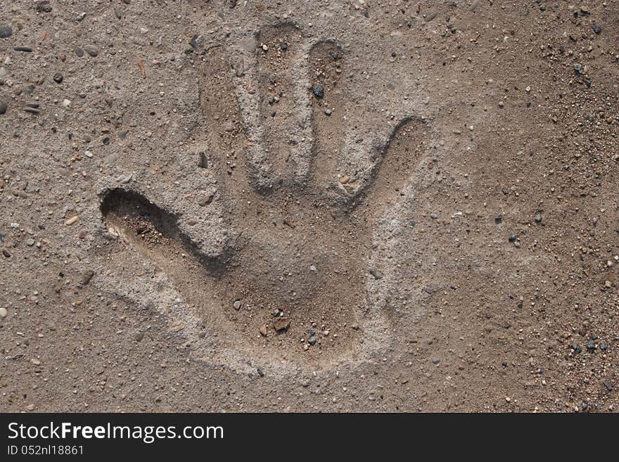 Imprint of a childs hand in cement