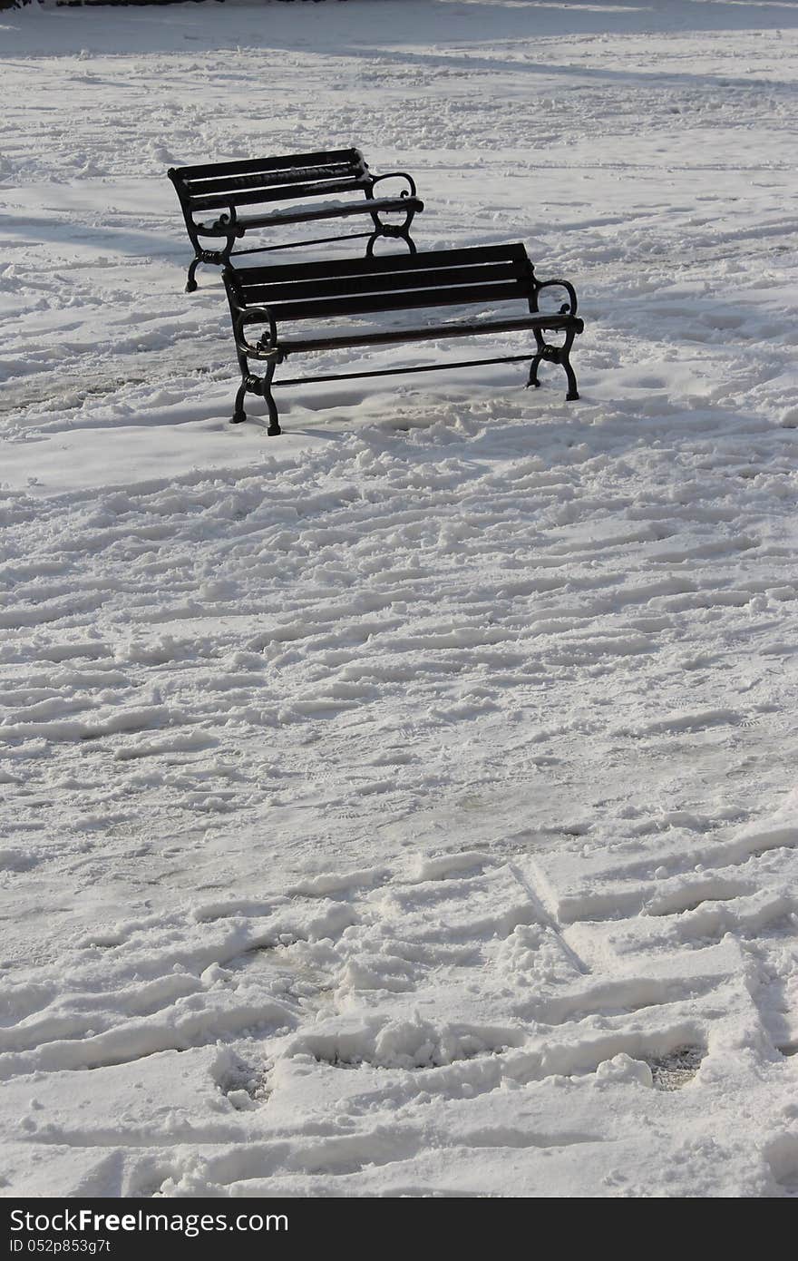 Two empty benches in the snow. Two empty benches in the snow