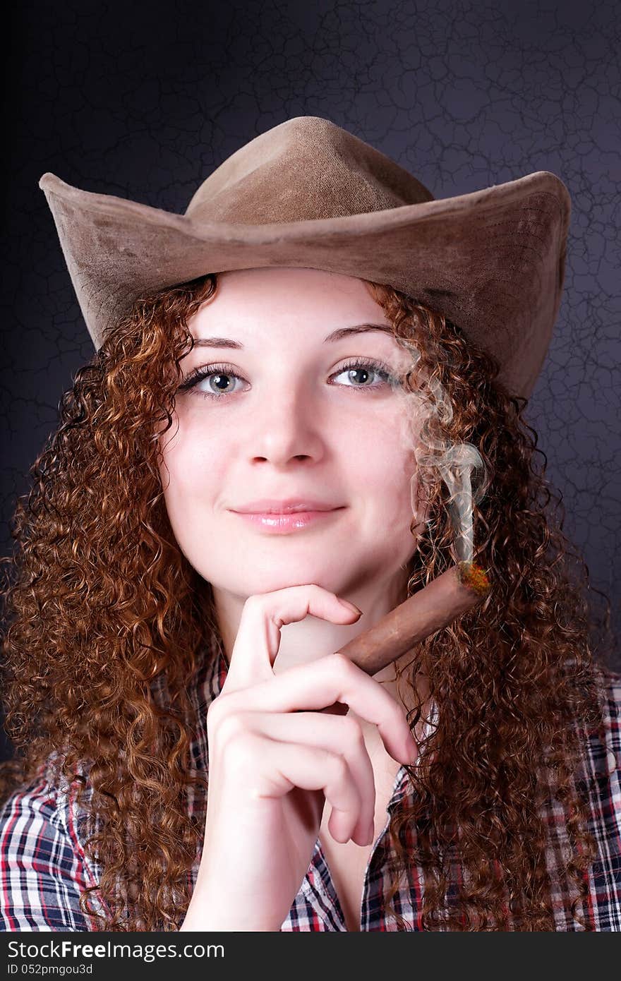 Pretty girl with a cigar cowboy