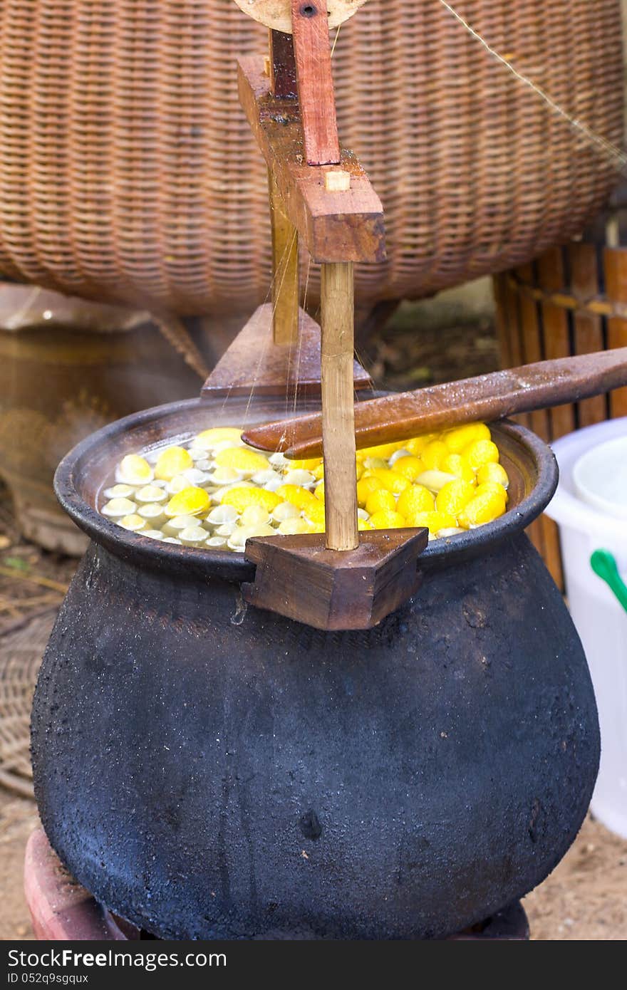 Boiling cocoon in a pot to prepare a cocoon silk.