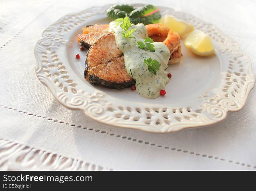 Roasted salmon with sauce, lemon and herbs