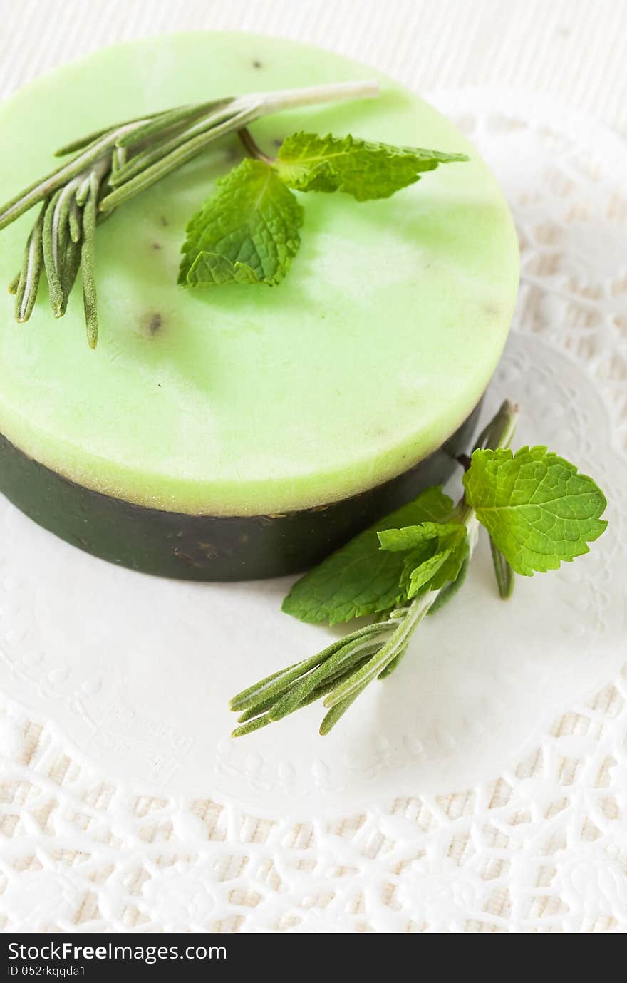 Handmade soap and mint leaves and a white background. Handmade soap and mint leaves and a white background