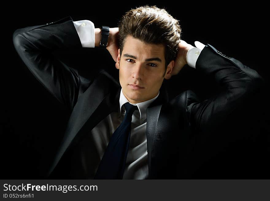 Portrait of a young businessman, isolated on black background