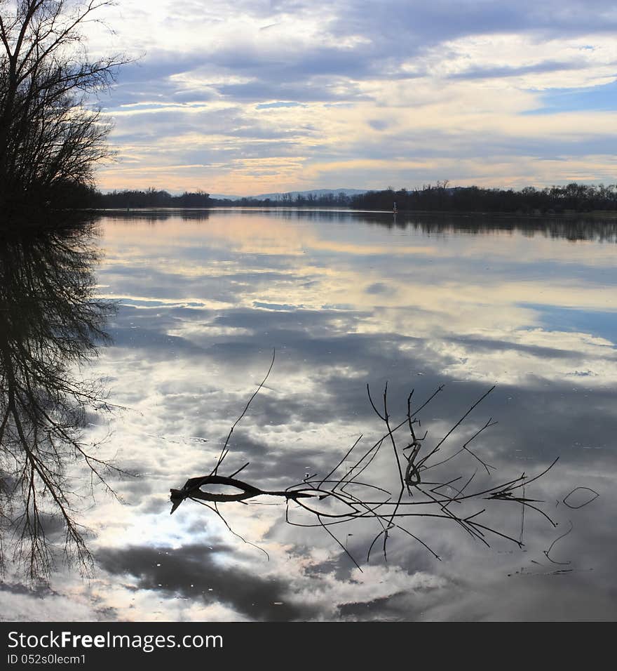 Sky, clouds and darkness reflecting in the river. Sky, clouds and darkness reflecting in the river