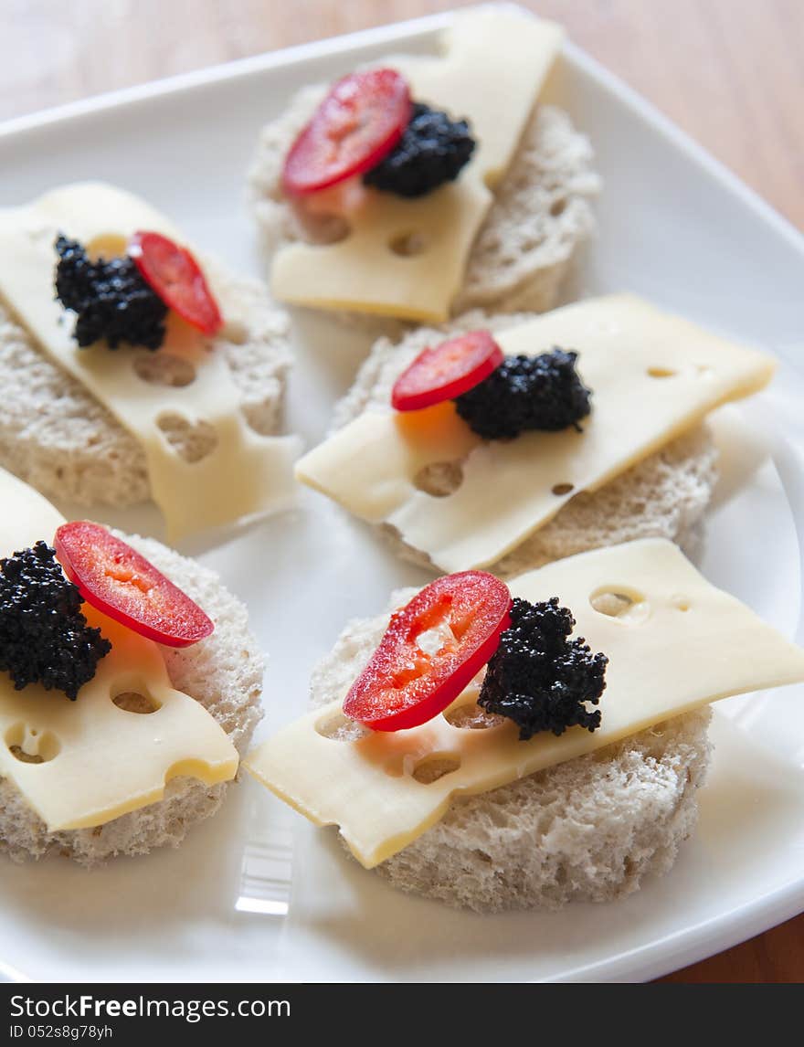 Caviar and cheese served as appetizer at parties
