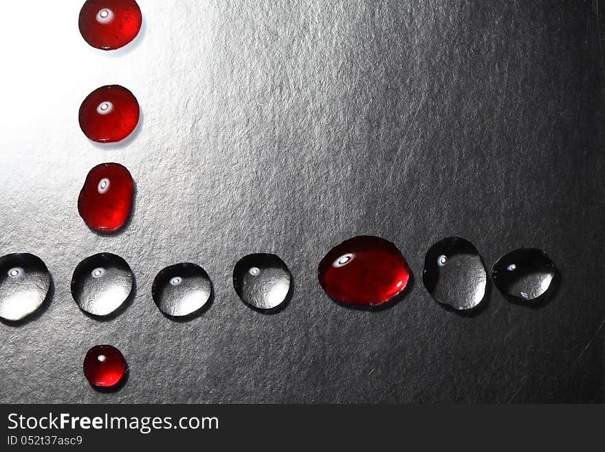 Red and transparent drops as border on dark background. Red and transparent drops as border on dark background