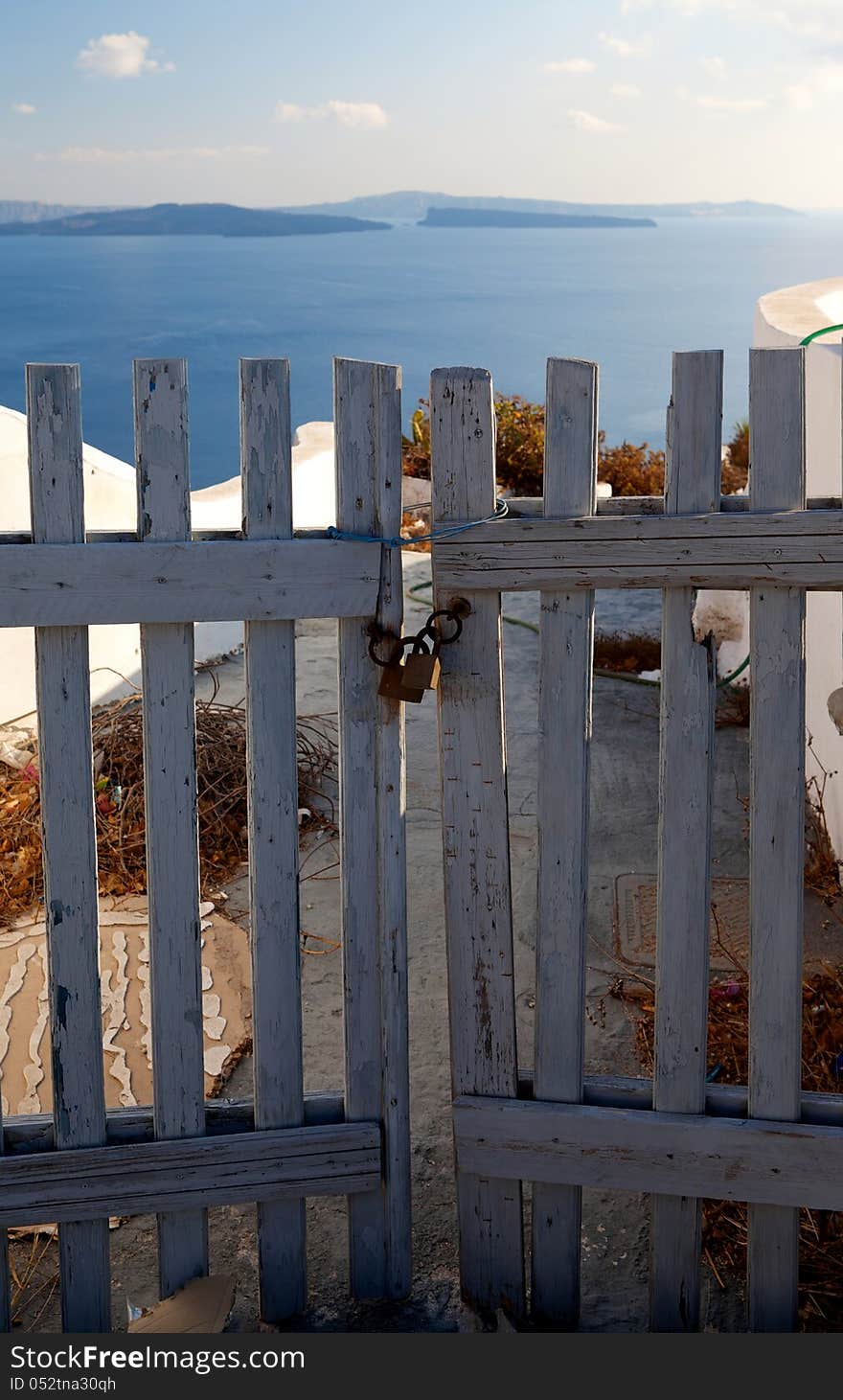 Wooden gates close access to the sea. Greece, Santorini island. Wooden gates close access to the sea. Greece, Santorini island