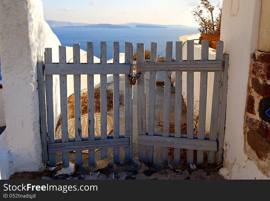 Wooden gates close access to the sea. Greece, Santorini island. Wooden gates close access to the sea. Greece, Santorini island