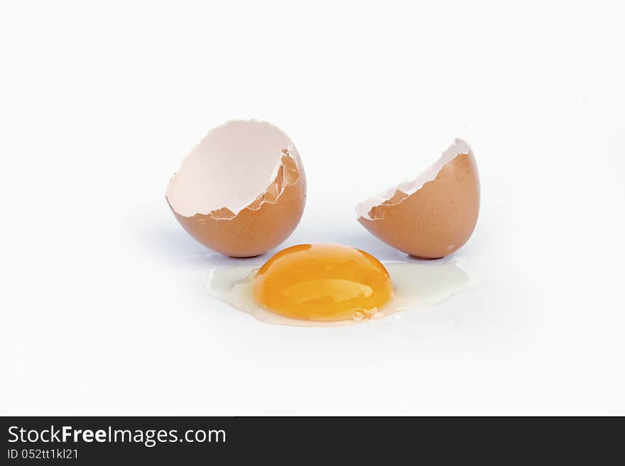 Broken brown egg on white background. Broken brown egg on white background