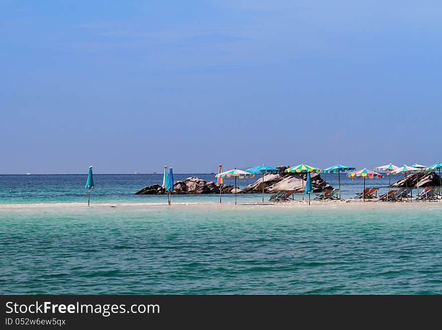 Umbrellas And Chairs On The Beach With Bluesky