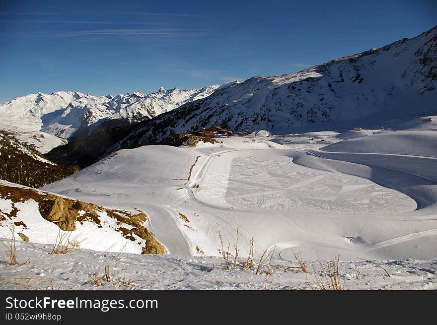 Geometrical drawing realized in the spotless snow of a mountain of the French Alps. Geometrical drawing realized in the spotless snow of a mountain of the French Alps.