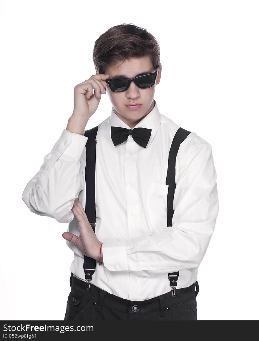 Fashion young man holding his fashionable sunglasses on white background