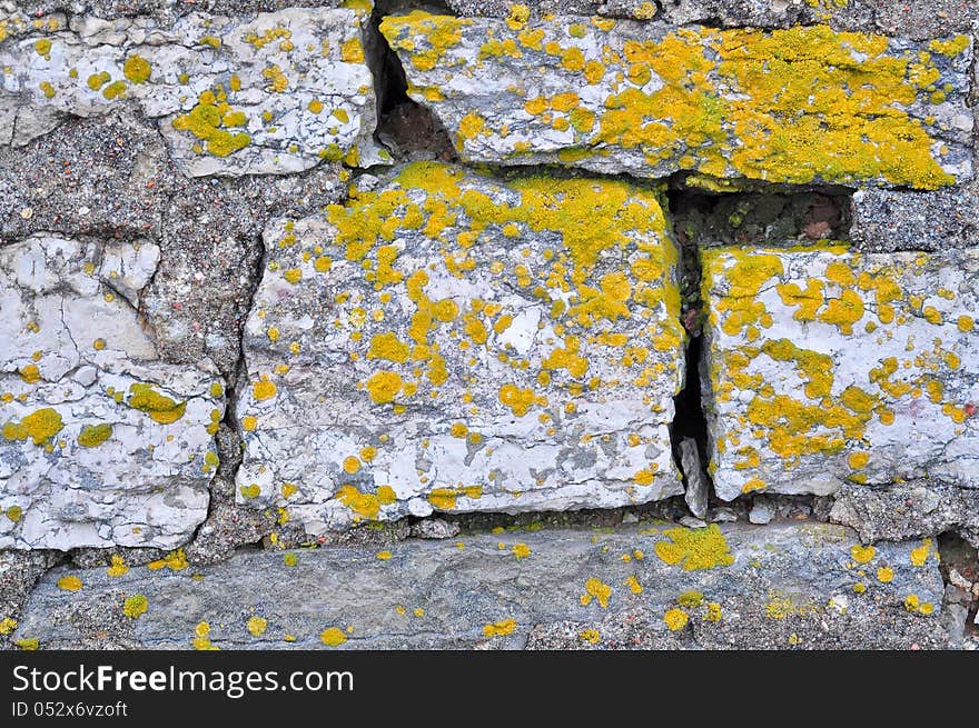 Rocks and lichen. Brick masonry of the old barn.