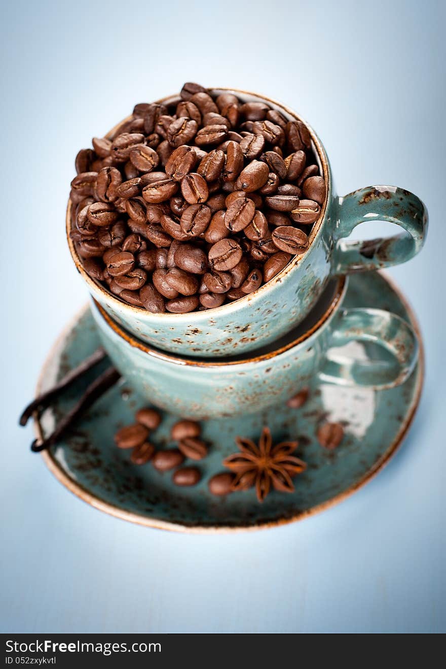 Coffee beans and spices in the blue cups