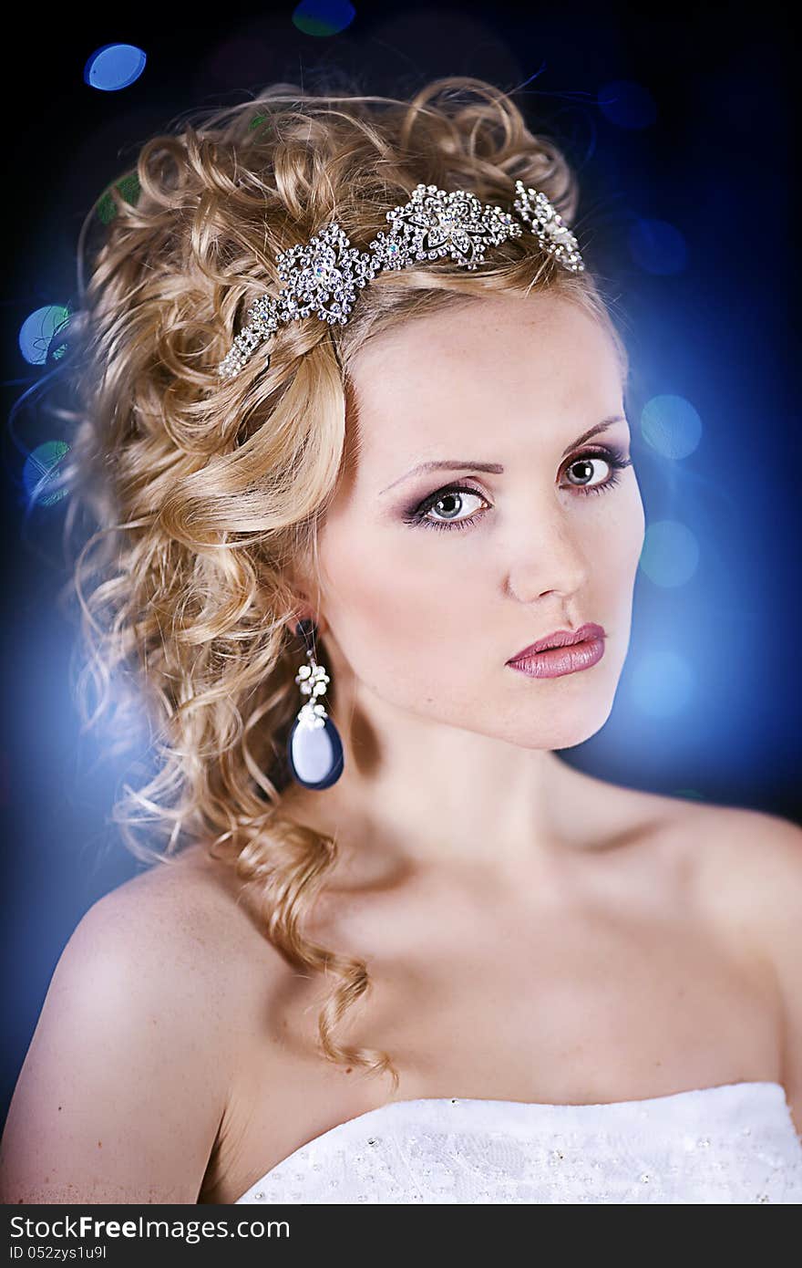 Portrait of a beautiful young bride in a white dress